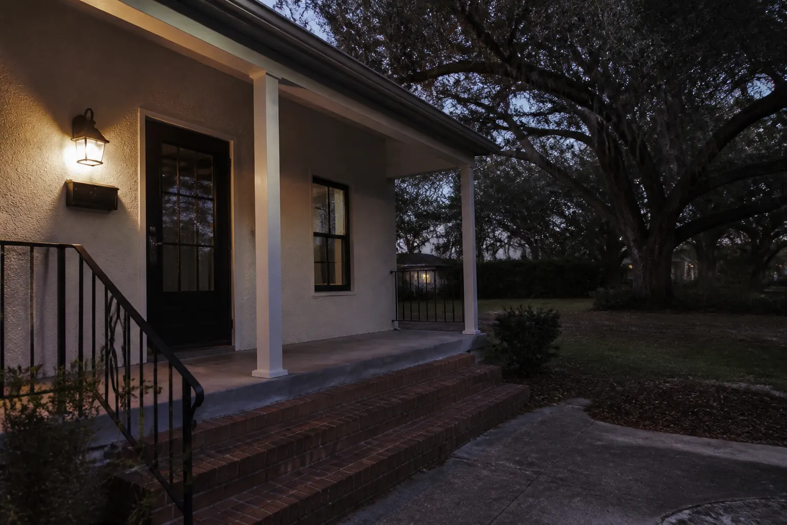 Outdoor lighting sconce on a Tampa porch at dusk